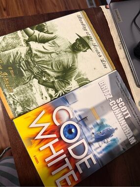 Set of 2 books, hardcover. Code white & standing on the scratch line